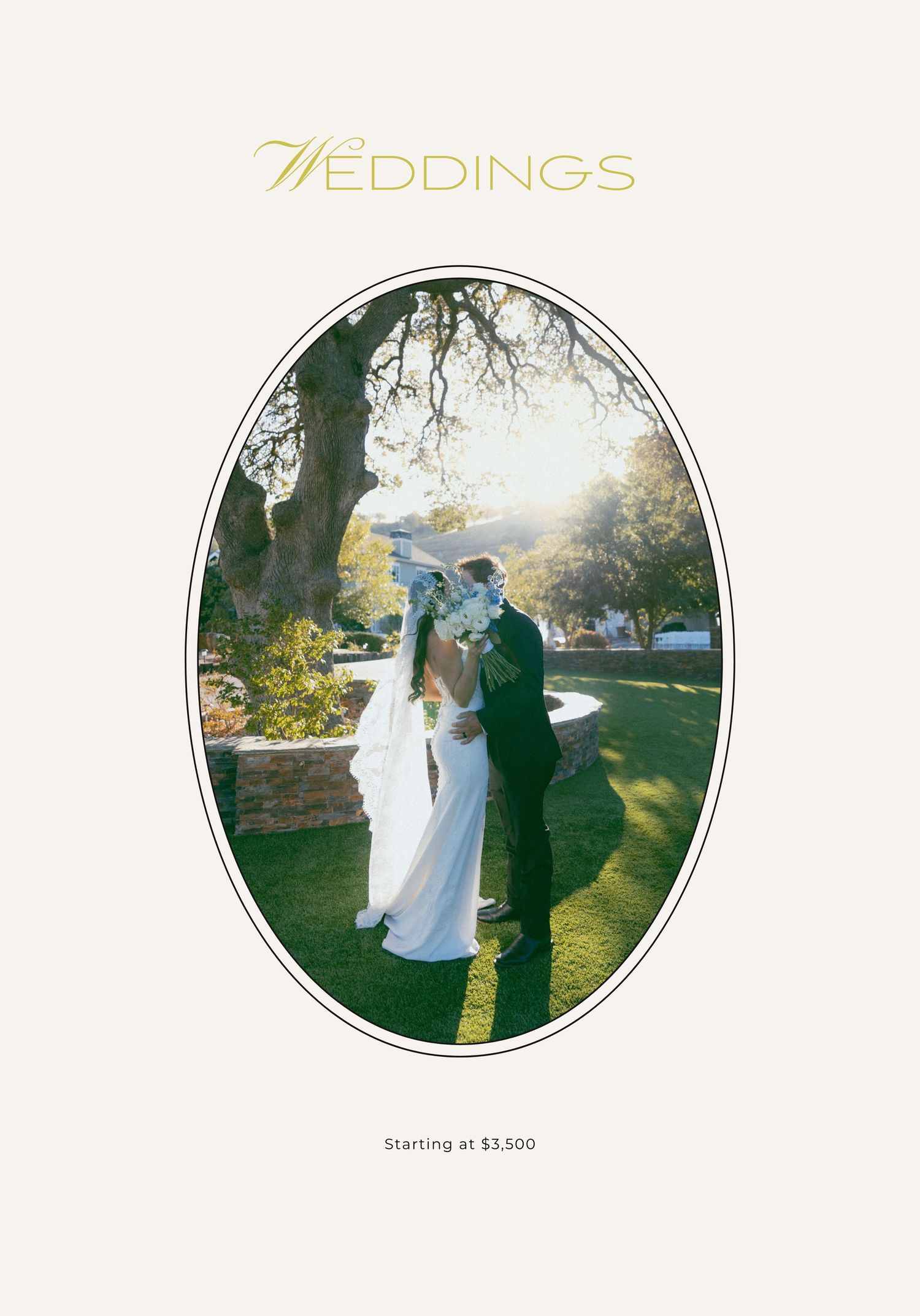 A couple in wedding attire poses outdoors on a sunny day with green grass and trees in the background.