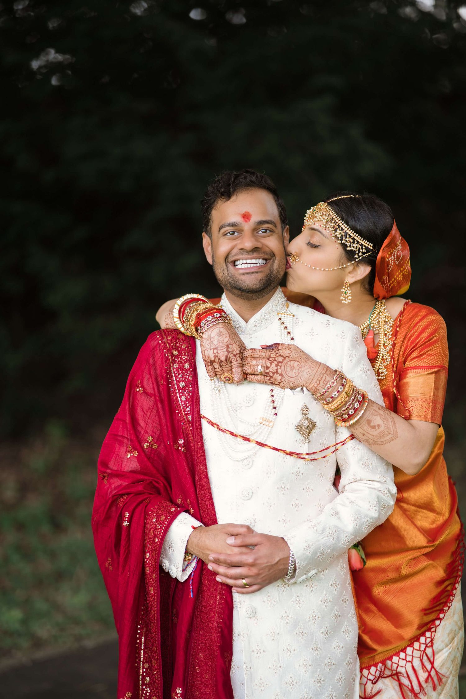 hindu couple first kiss after mandap ceremony, smiling with love