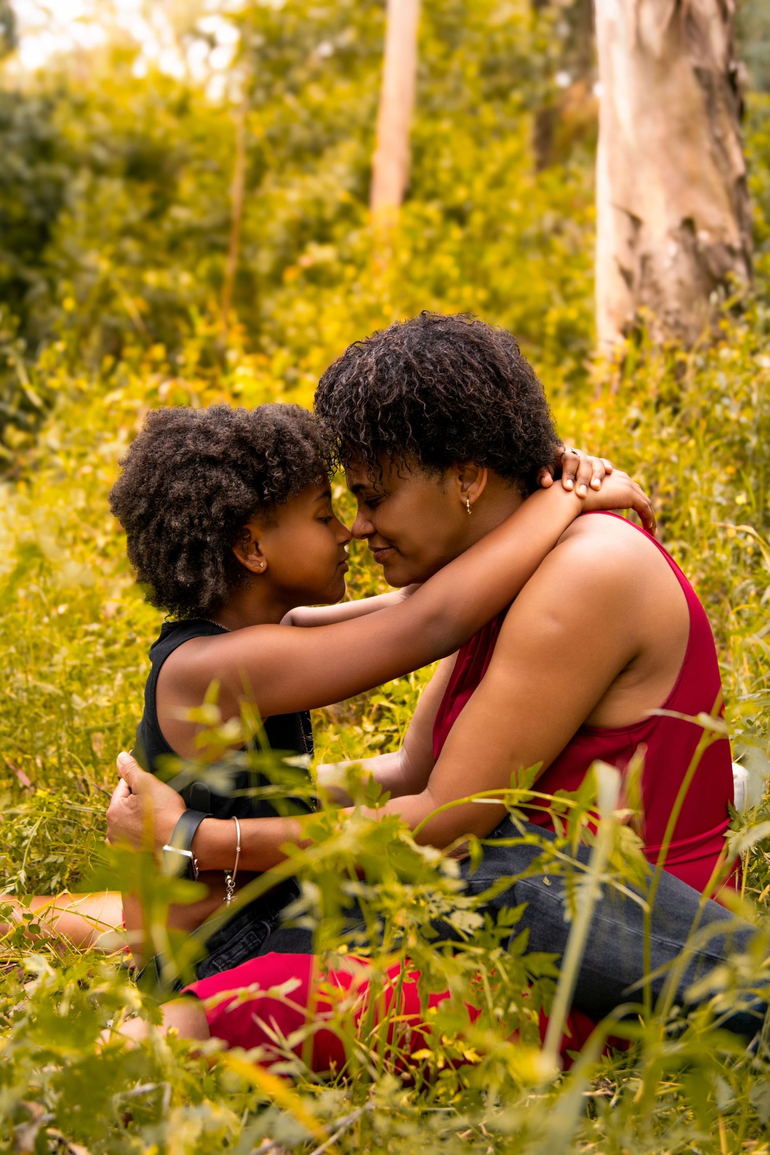 Intimate embrace among wildflowers in warm evening sunlight.