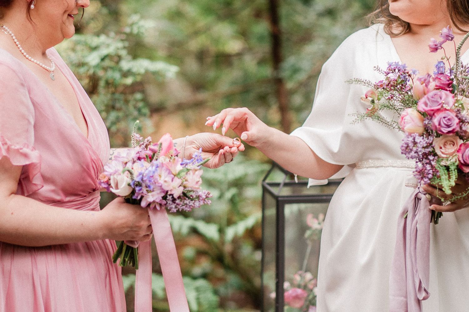 bridesmaid giving ring to bride during ceremony. Photo by Pine + Vow