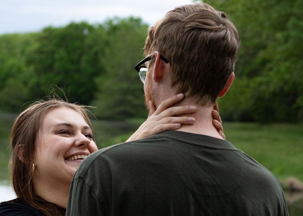 Candid moment of laughter between two people in a natural setting.