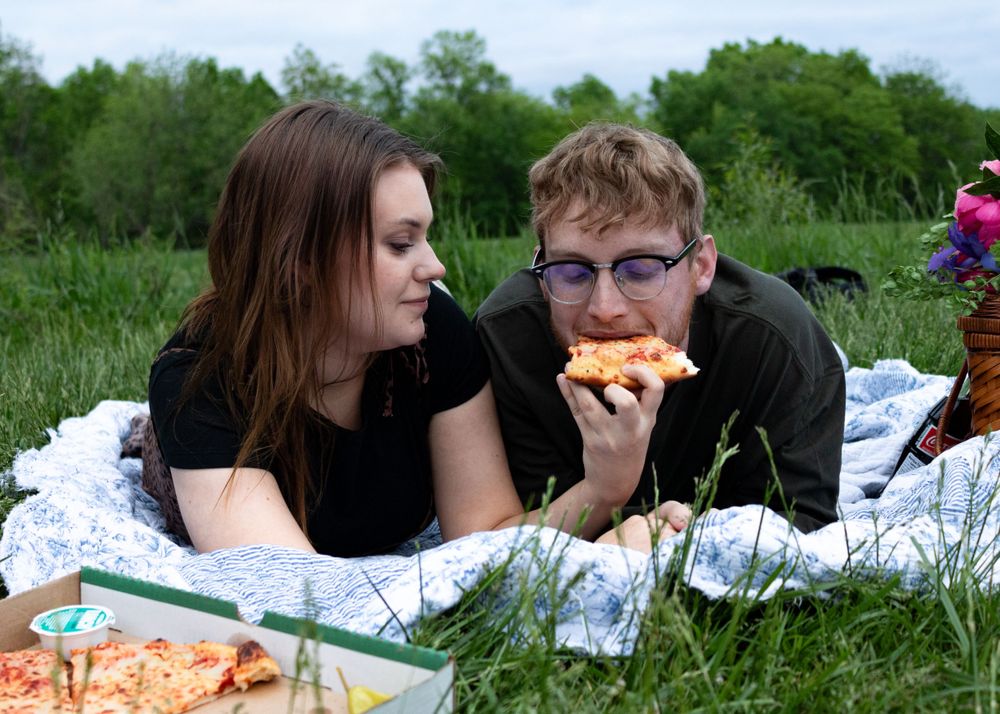 A series of candid moments from a couple's lakeside picnic date.