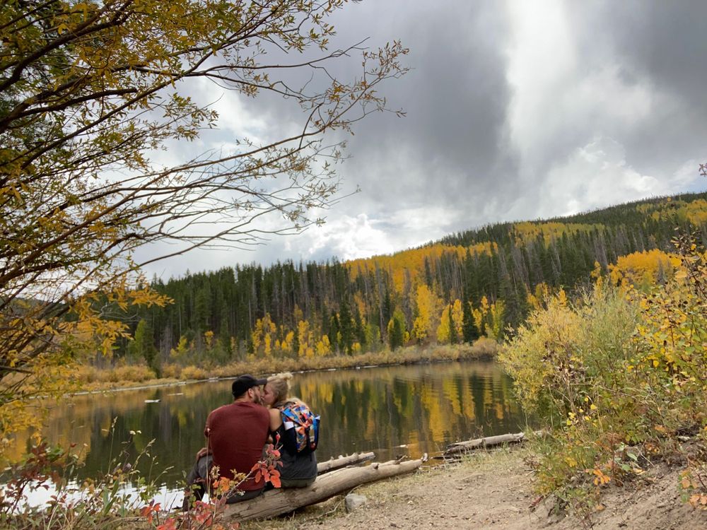 Couple sitting lakeside in Colorado