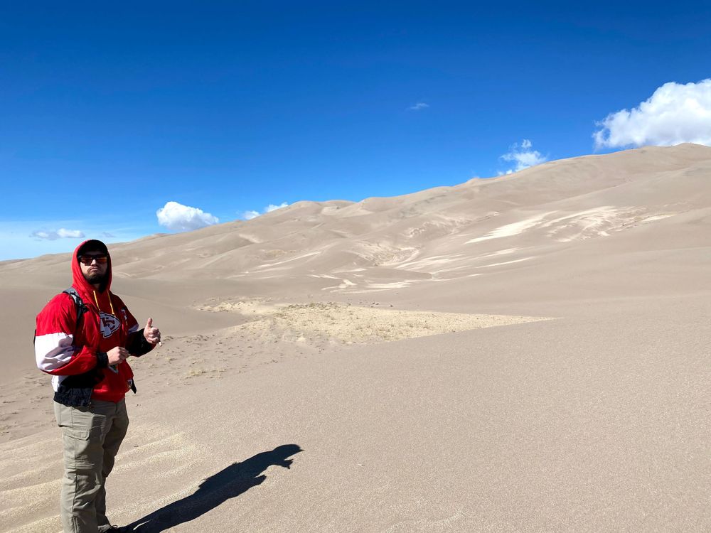 Man standing on sand dunes in Colorado