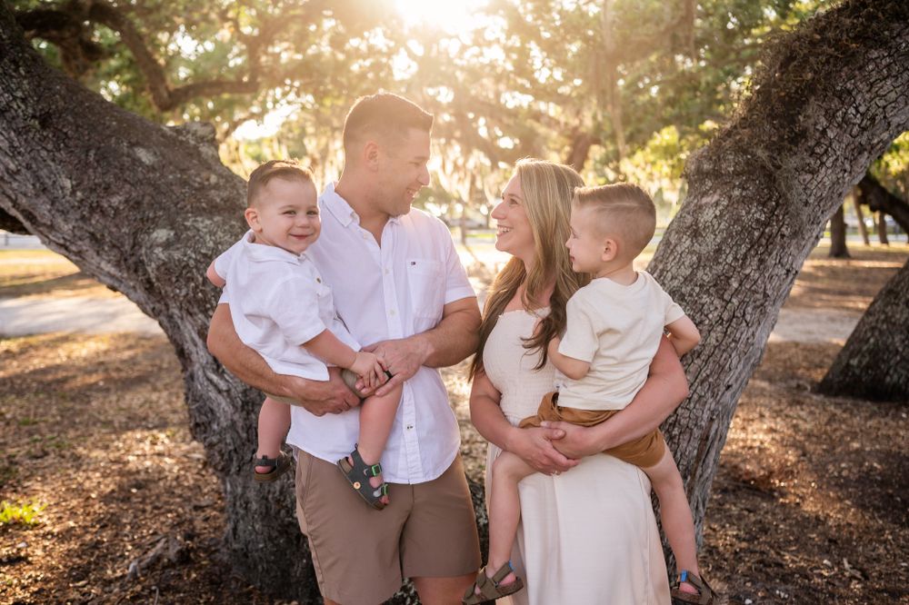 Family photoshoot session with two children standing candid smiling park sunset trees Palm Bay Cocoa Beach Vero Florida Brevard County