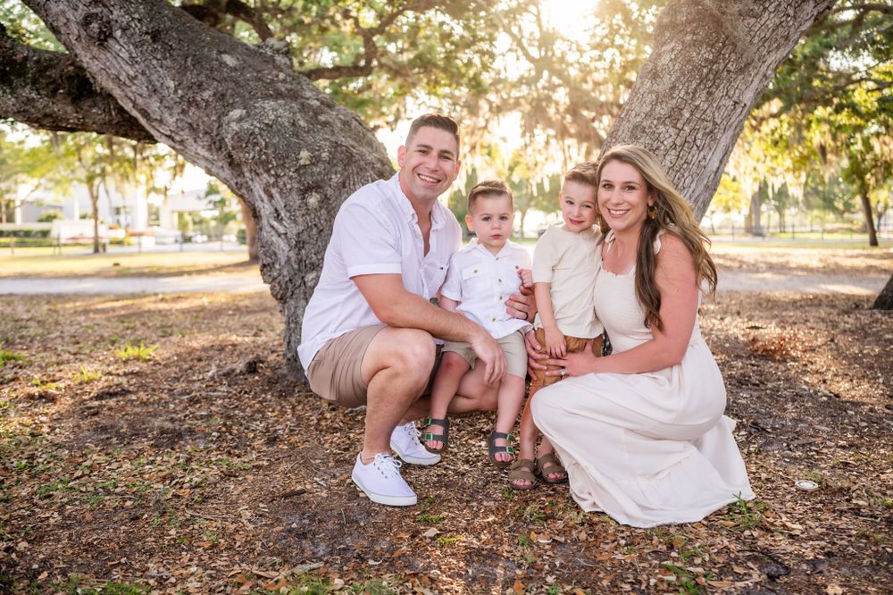 Family photoshoot session with two children sitting together park sunset trees Palm Bay Cocoa Beach Vero Florida Brevard County