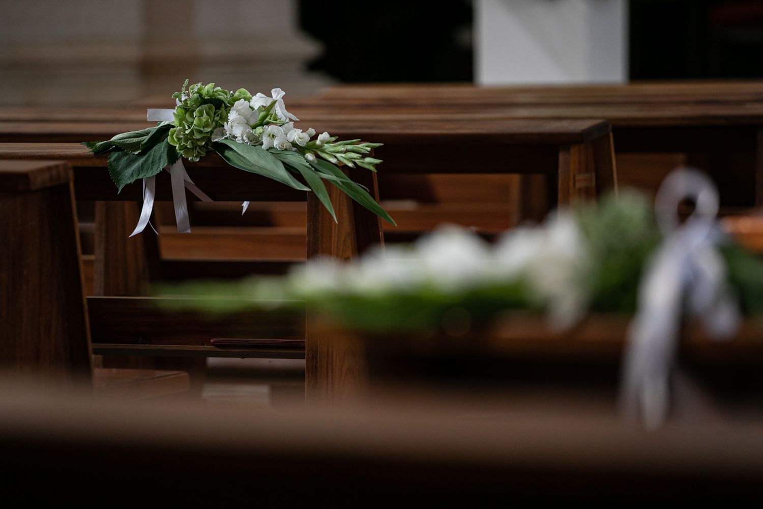 Decorative floral arrangements and greenery displayed in a church setting.