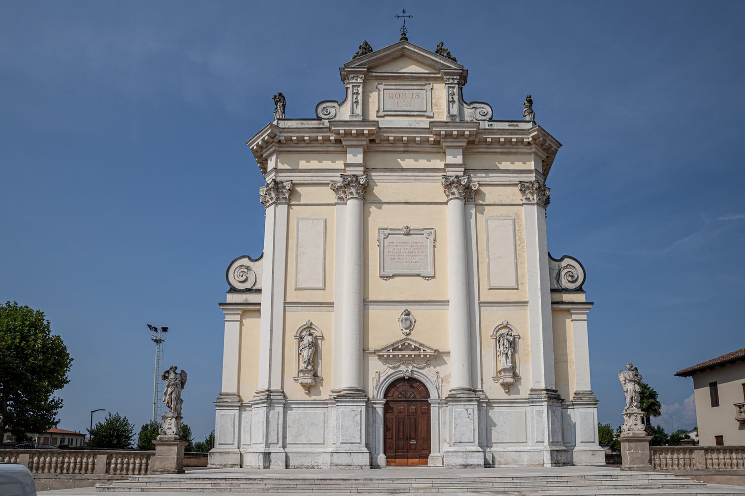Exterior view of a grand white church facade with classical architecture.