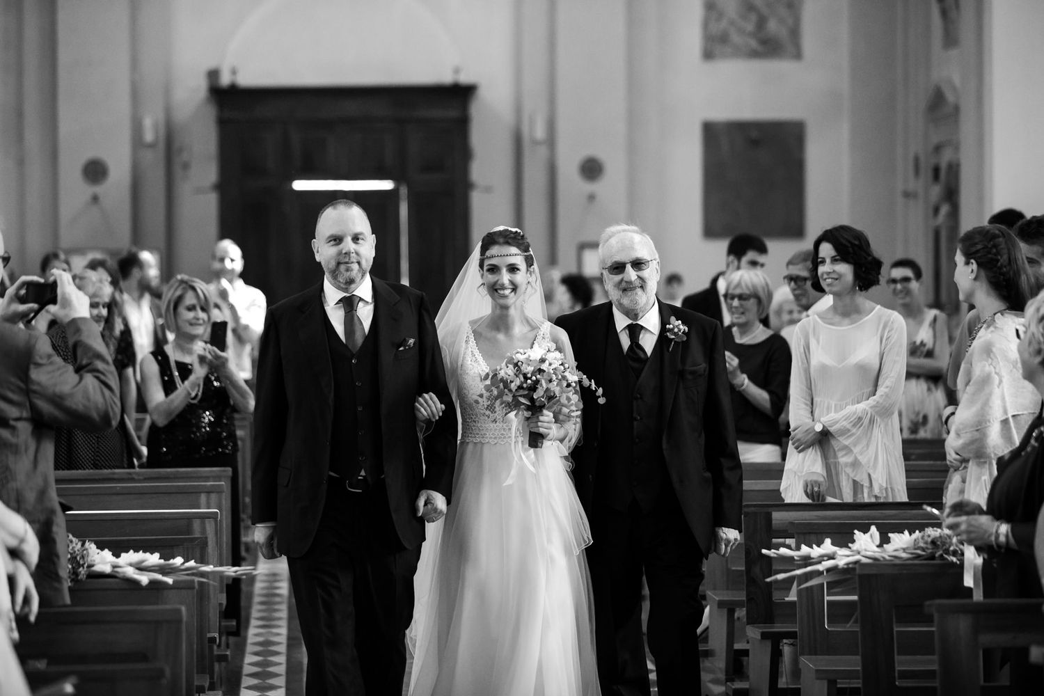 Traditional church wedding ceremony procession in black and white.