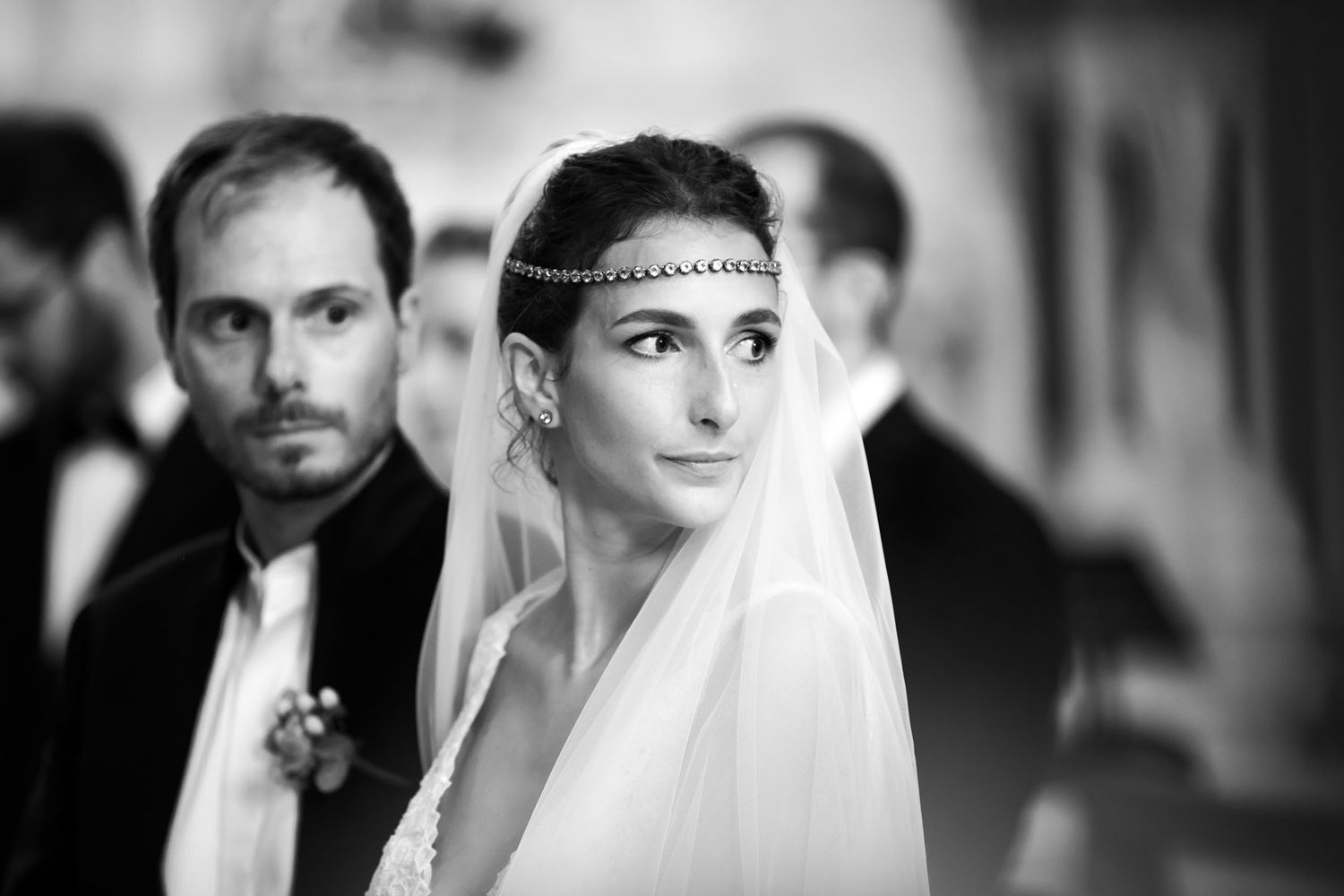 Elegant black and white portrait of couple in wedding attire.