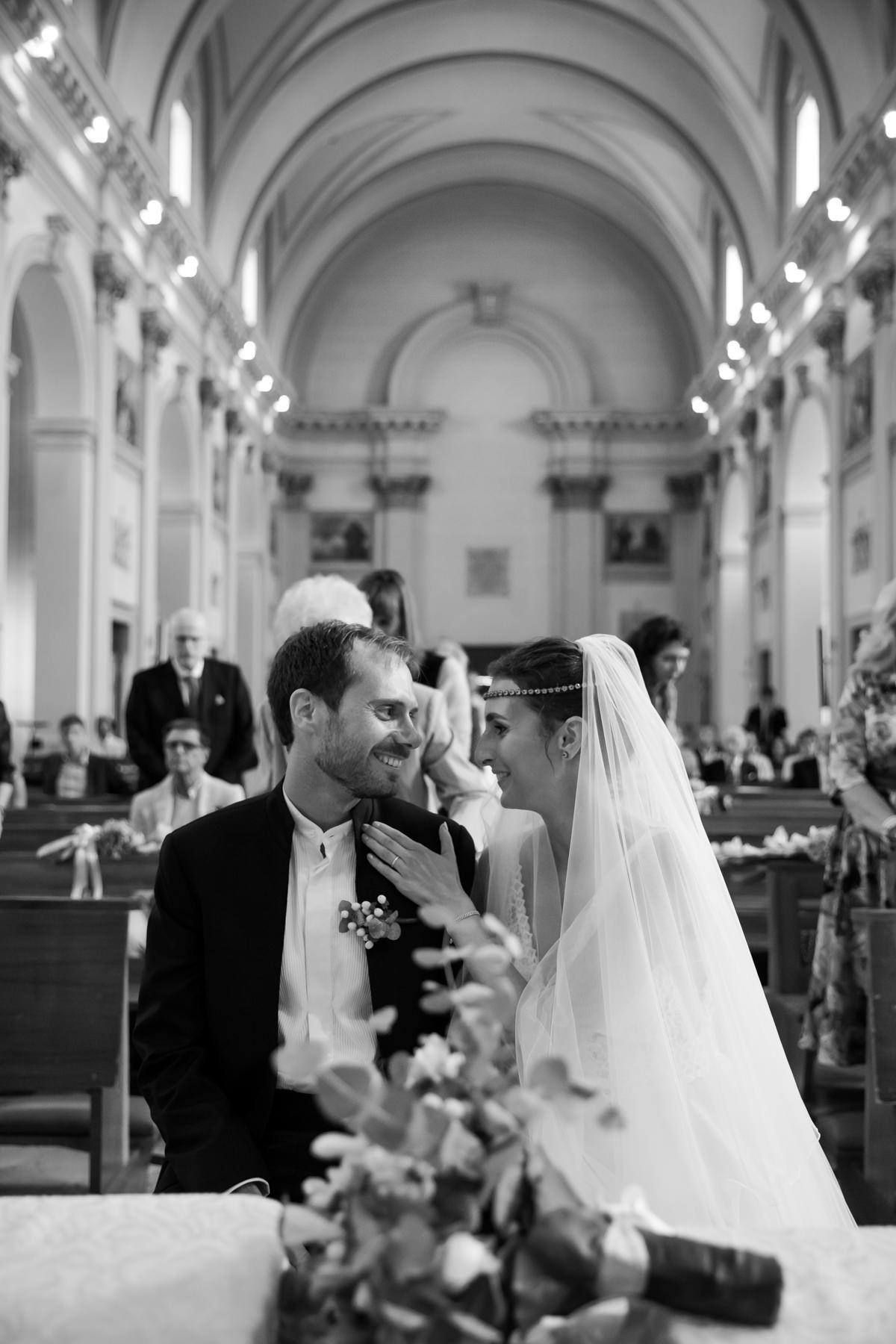 Intimate moment between couple during church wedding ceremony.