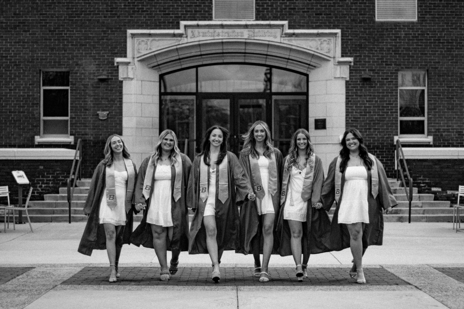 A group of grads walking together towards the camera