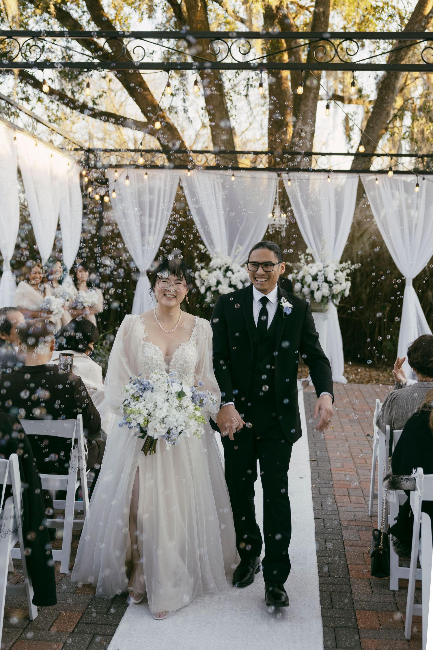 A romantic wedding portrait with white veil flowing in the breeze.