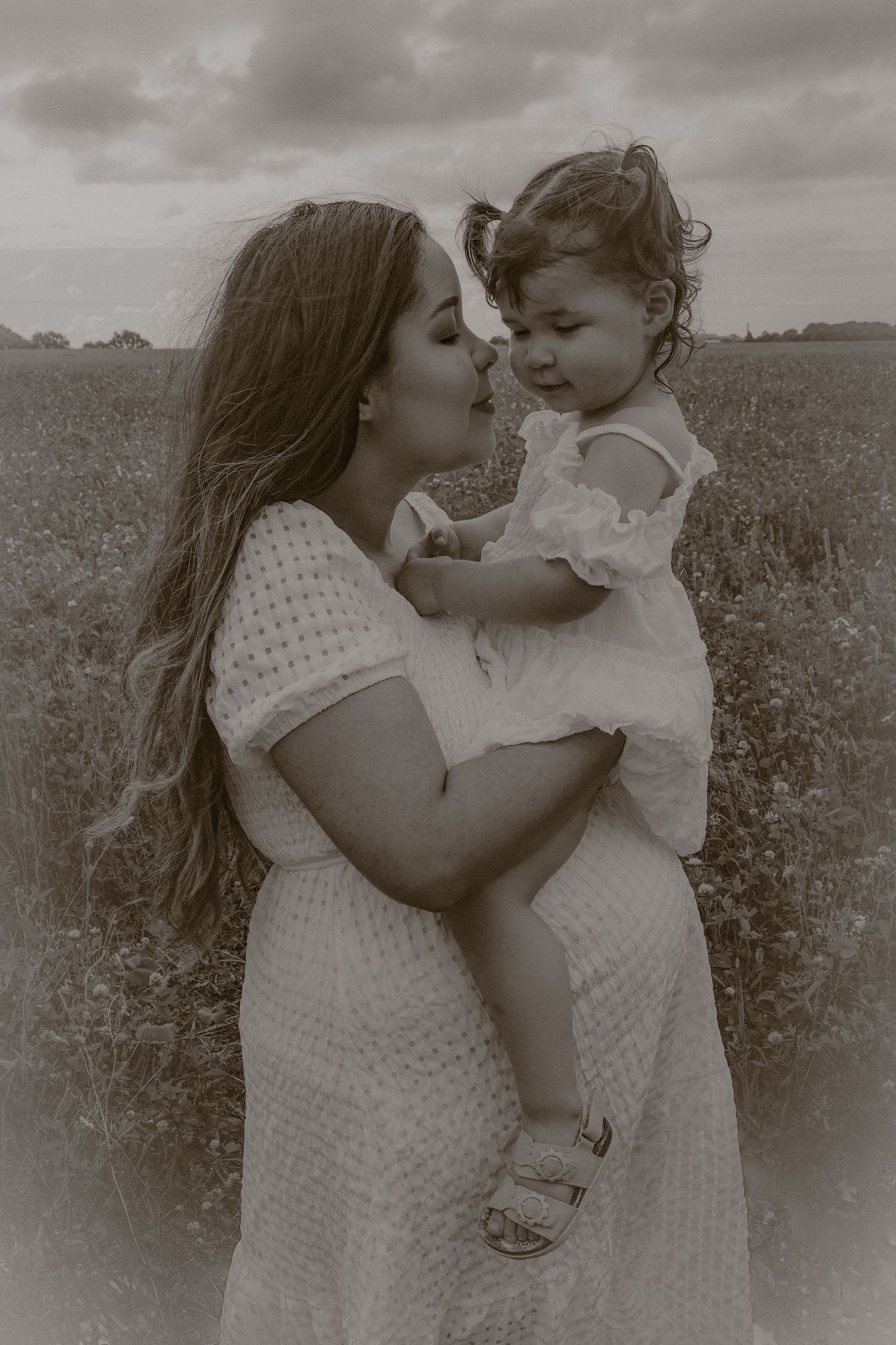 maternity,n orfolk, monochrome, grainy, vintage, nostalgic, natural light, poppy field mum with toddler in arms sitting on her bump