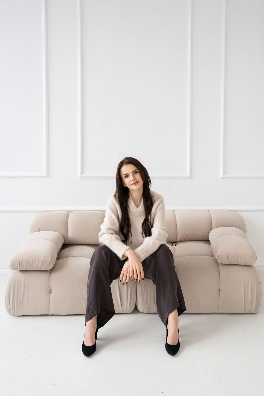 A sequence of photos showing a person in dark pants and white sweater sitting on a beige modular sofa in different poses.
