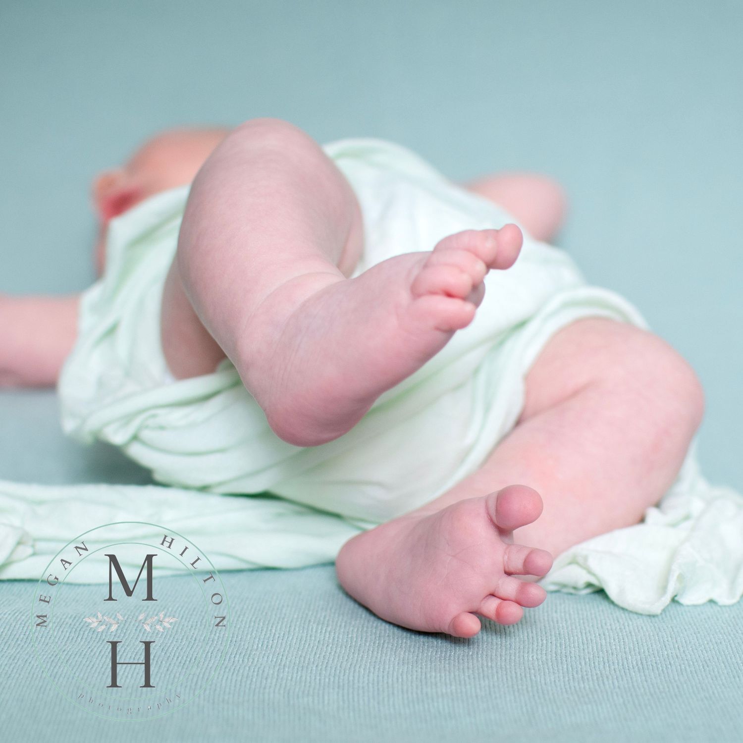 baby toes on mint green backdrop