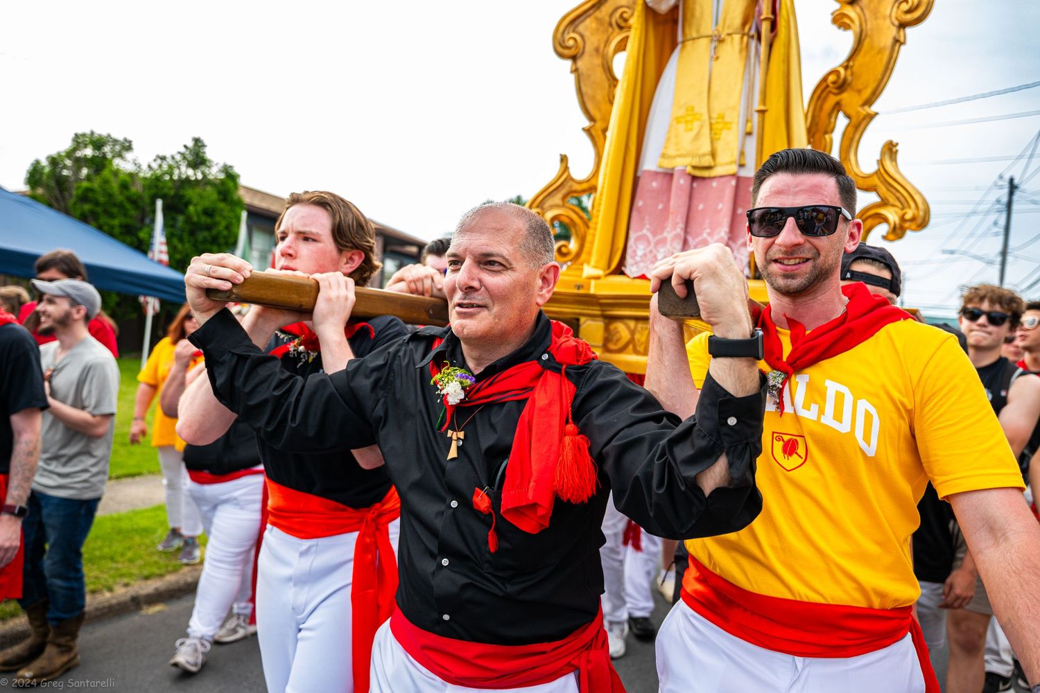 Group performing in traditional red and white costumes during a cultural festival.