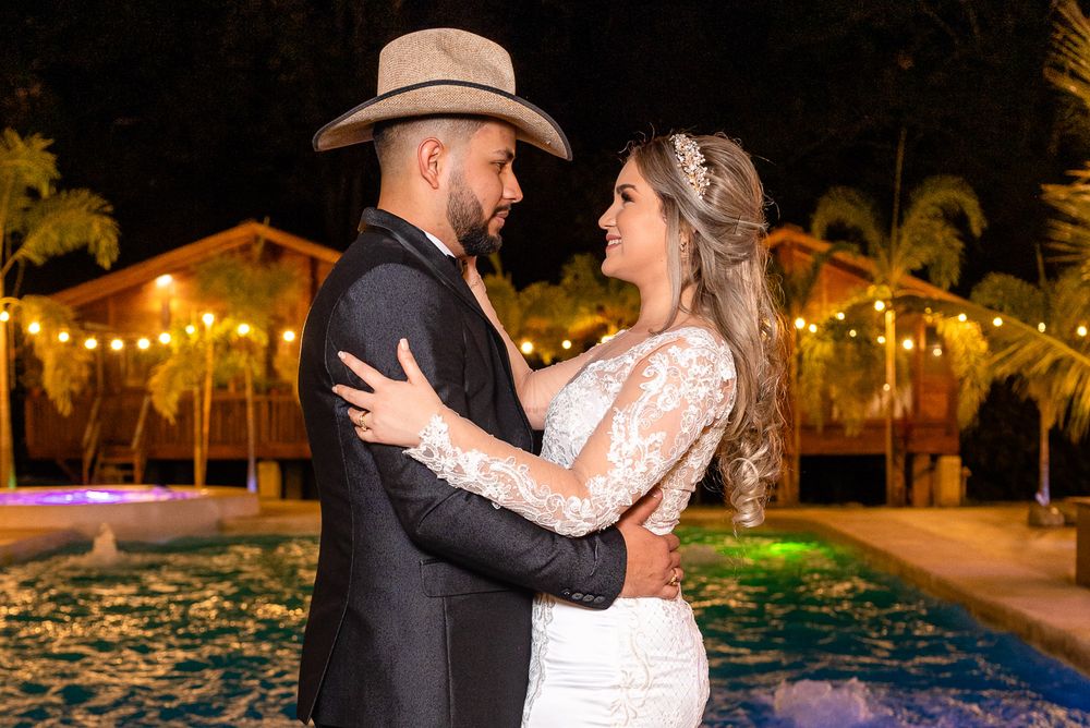 Wedding celebration at night with string lights creating a warm romantic atmosphere.