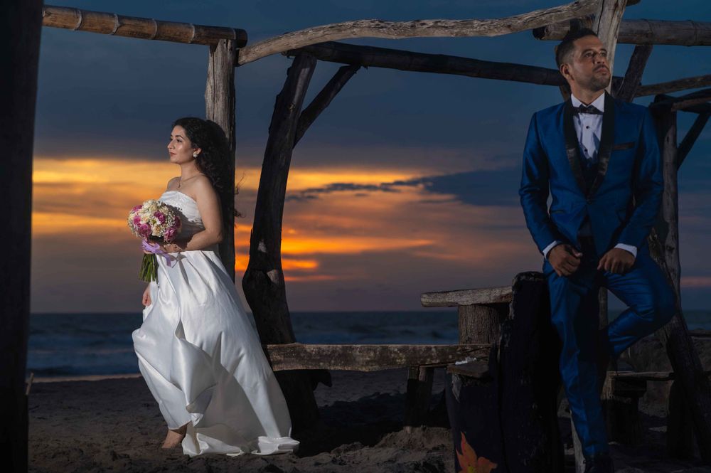 Romantic sunset silhouettes against a dramatic orange and blue sky.