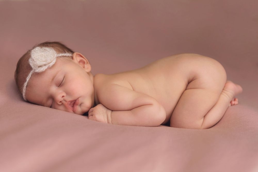 Newborn baby girl with classic posing taken in client home
