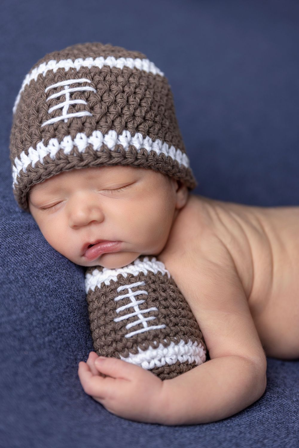 Newborn baby boy with custom football outfit