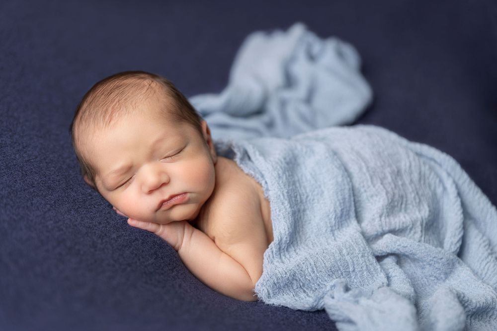 Newborn baby boy classic posing taken in client home