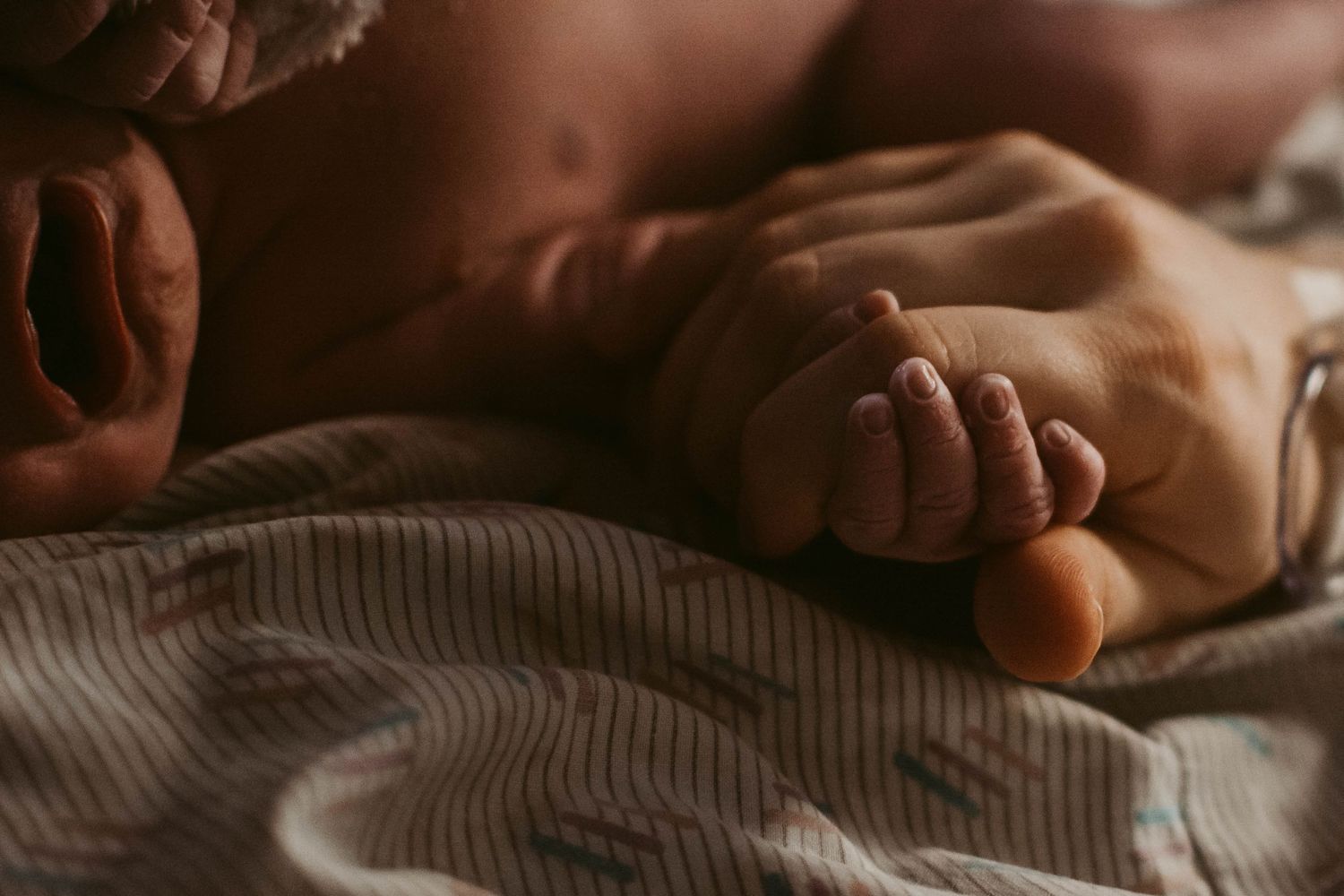 Close-up view of hospital bedding in warm lighting.