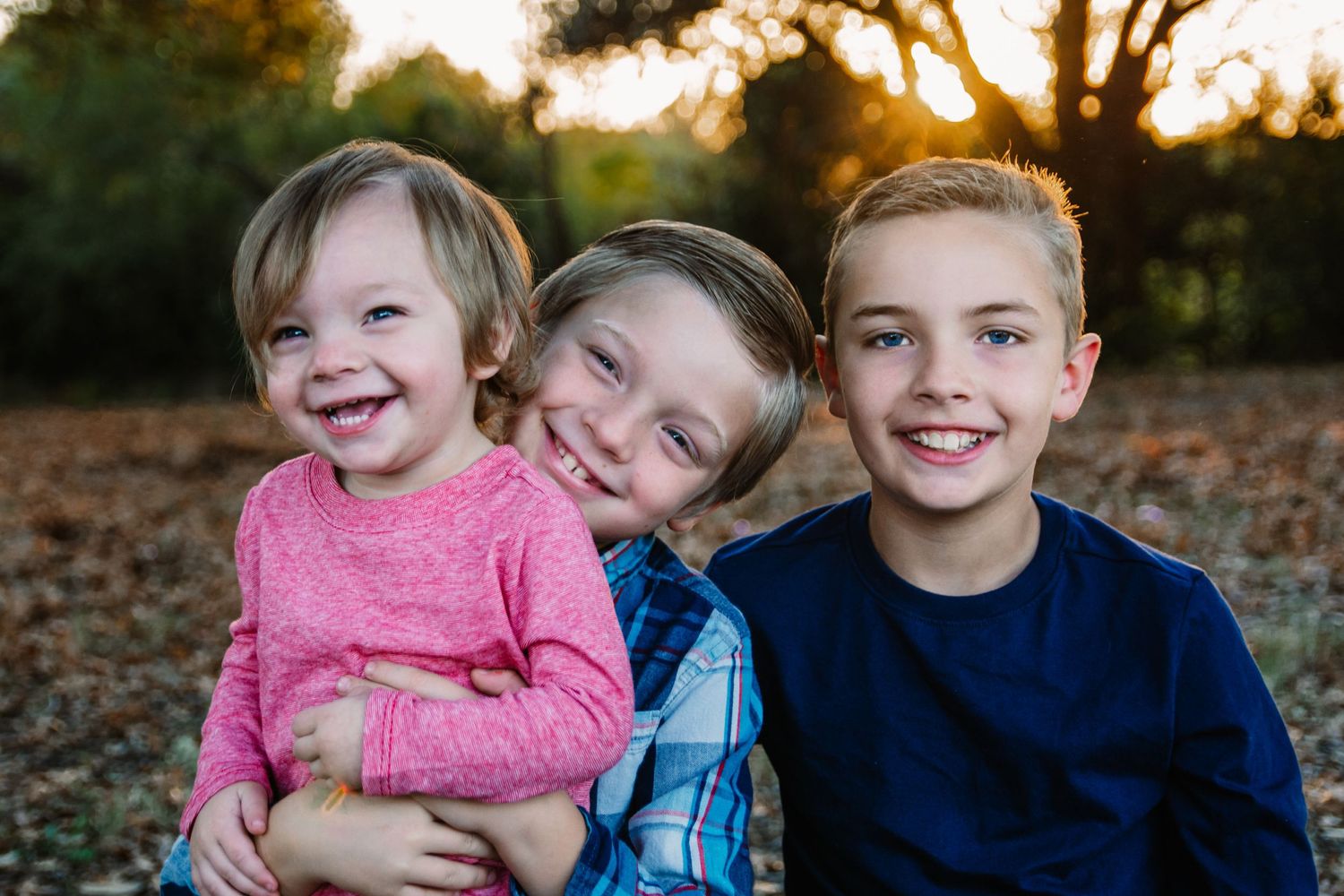 3 brothers together smiling at camera during dallas area family photo session by mesquite, tx photographer
