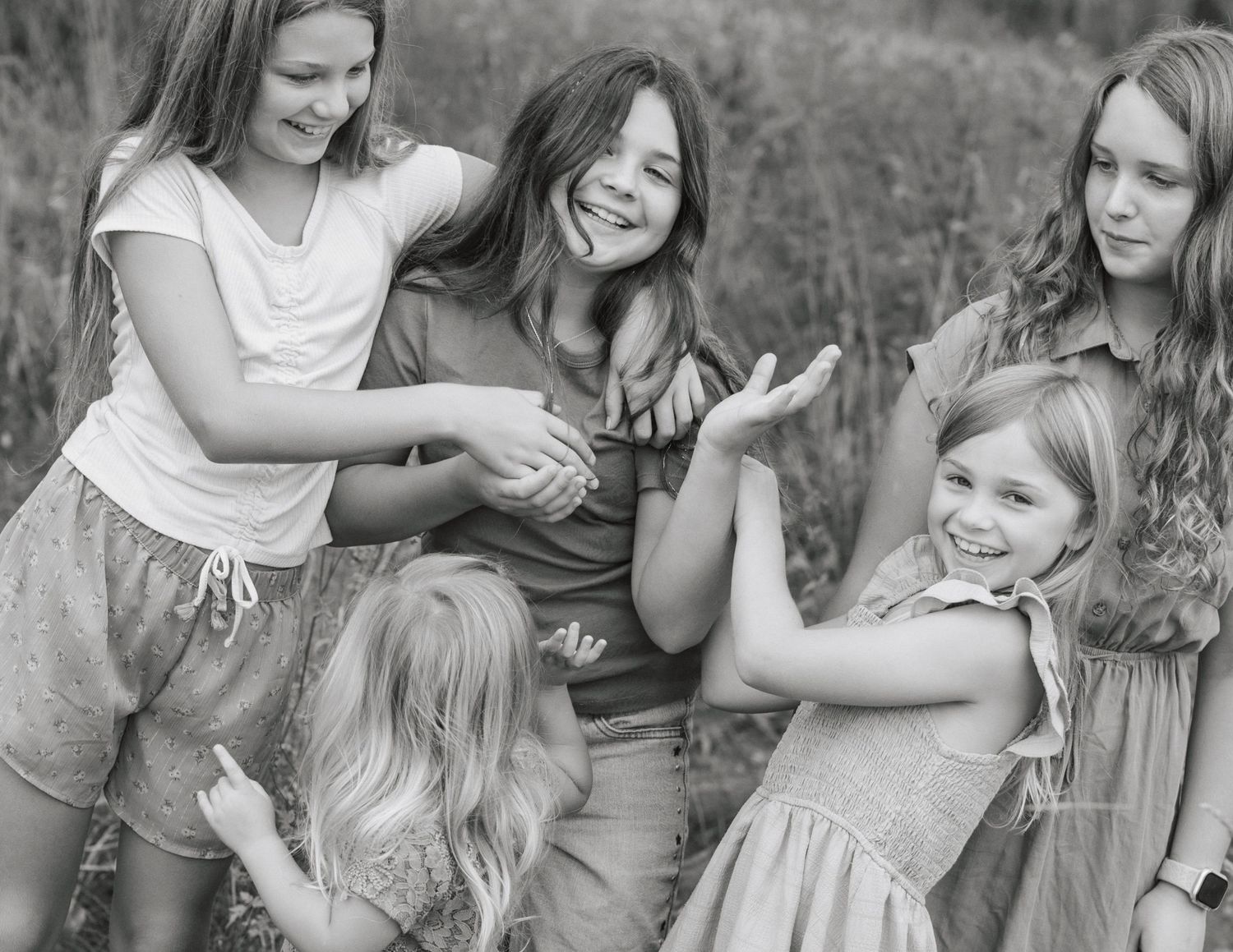 Fun and interactive sibling photo on family property in Goodrich, MI