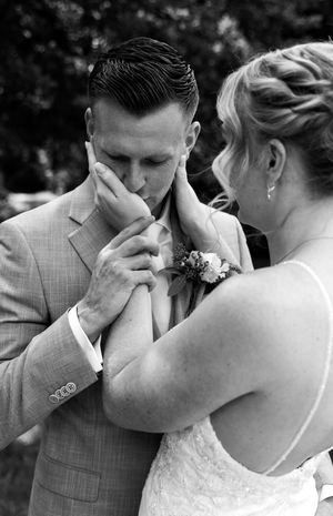 Black and white wedding moment showing emotional expressions during a special ceremony.