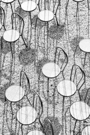 Abstract black and white pattern of circles and vertical lines creating a textured background.