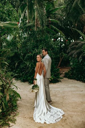 Elegant wedding photos in a lush tropical garden setting with flowing white gown.