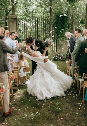 Joyful wedding dance sequence with flowing white dress twirling in a forest setting.