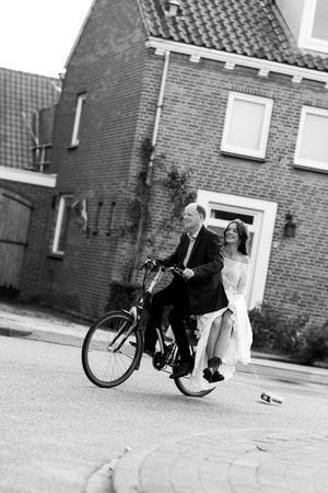 Vintage-style black and white sequence of playful moments with a bicycle.