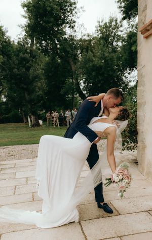 Romantic wedding sequence on stone steps with flowing white dress.