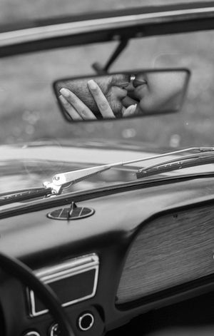 Close-up detail of vintage car dashboard in black and white.