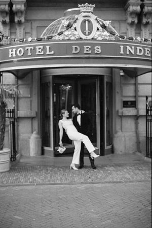 Black and white photos of wedding couple at historic Hotel des Indes entrance.