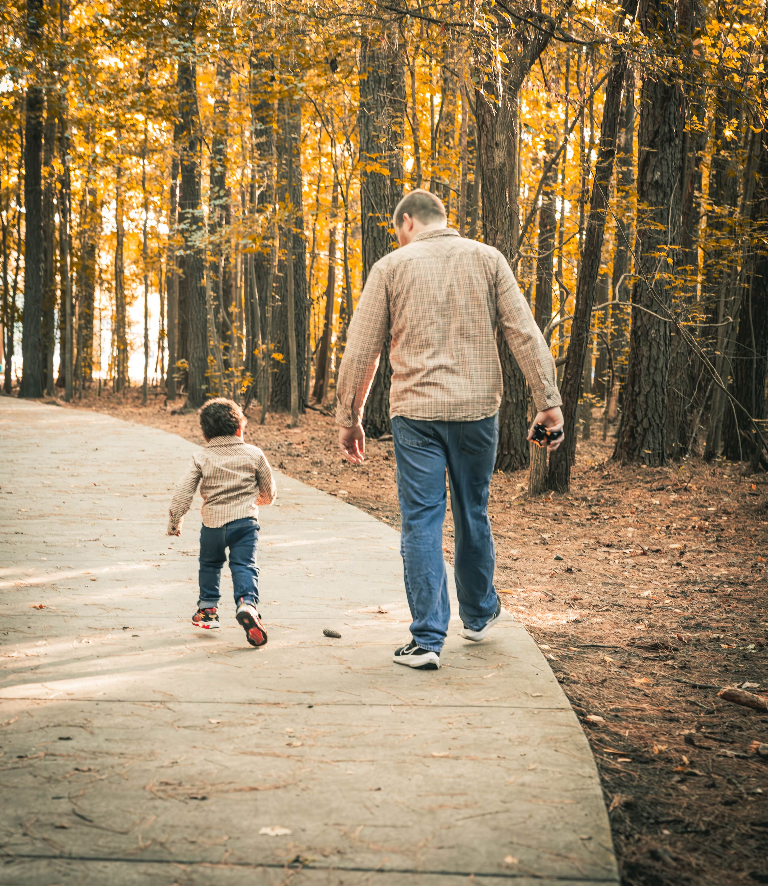 Father and son Walking down a trail at Oak Groove Lake Park in Chesapeake Virginia