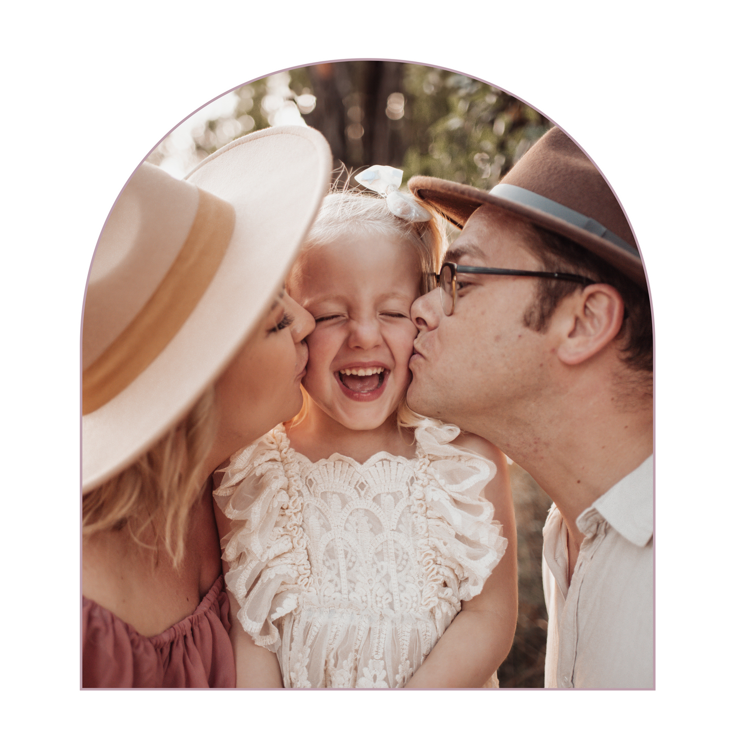 Sweet family moment captured outdoors with natural lighting and vintage styling.
