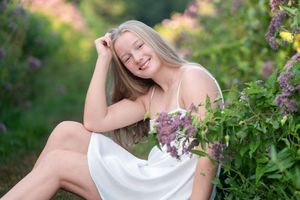 A series of romantic outdoor portraits featuring someone in a white dress among blooming lilac bushes in springtime.
