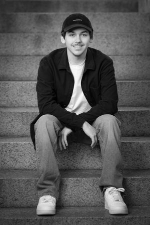 Black and white portrait series showing someone sitting on concrete steps wearing a baseball cap and casual attire.