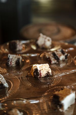Close-up macro shot of chocolate Oreo cookie crumbs scattered on dark surface with shallow depth of field.