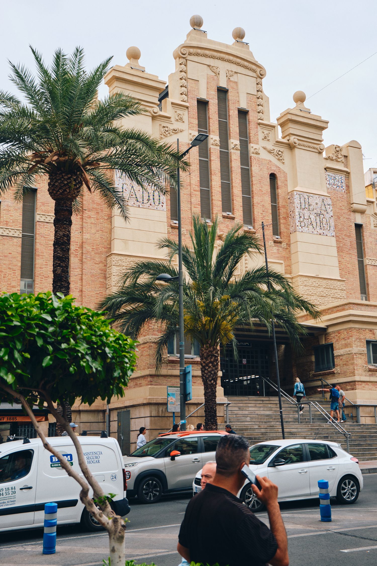 Art deco style Mercado Central building with palm trees in foreground.