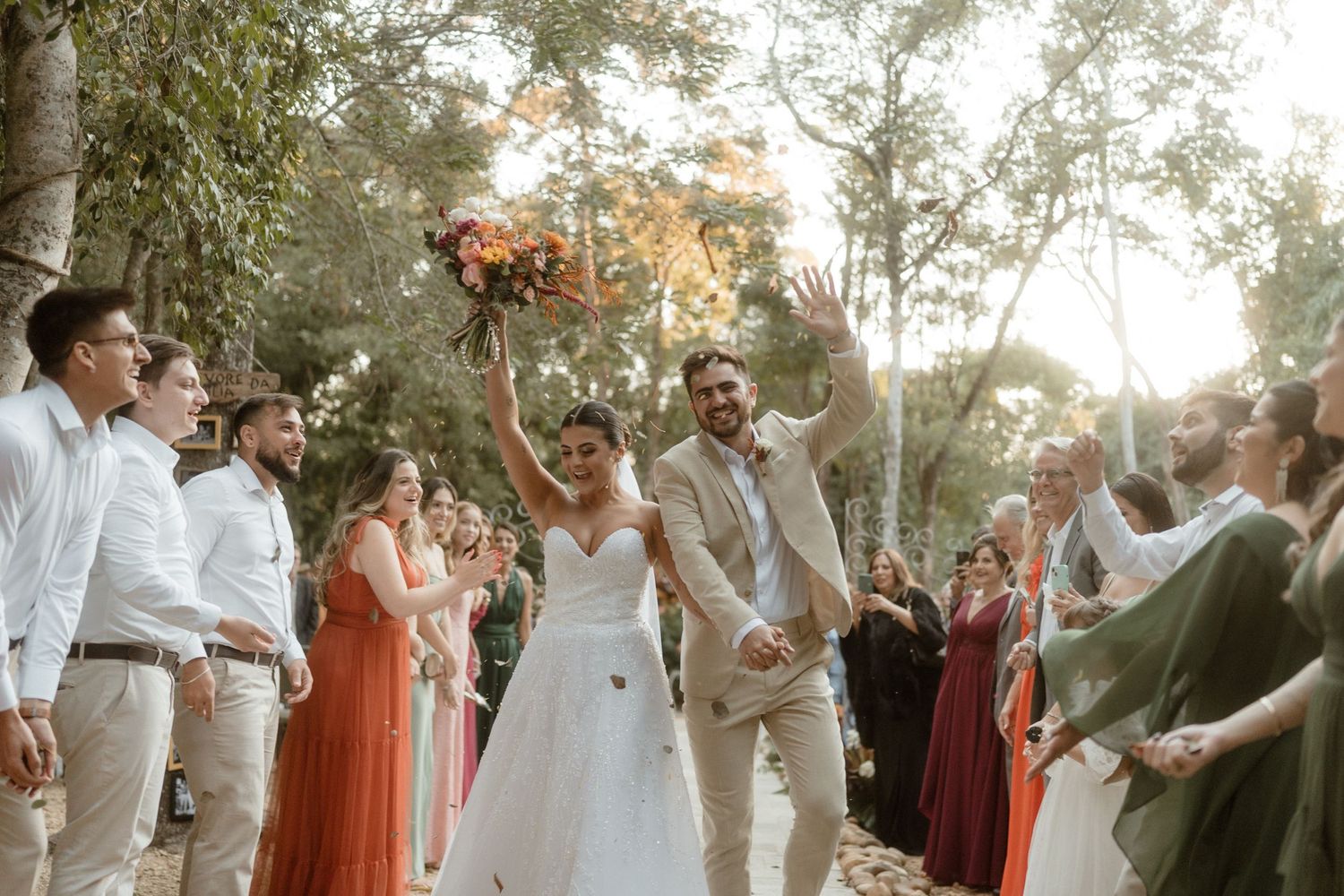 Wedding celebration in outdoor garden setting with natural lighting.