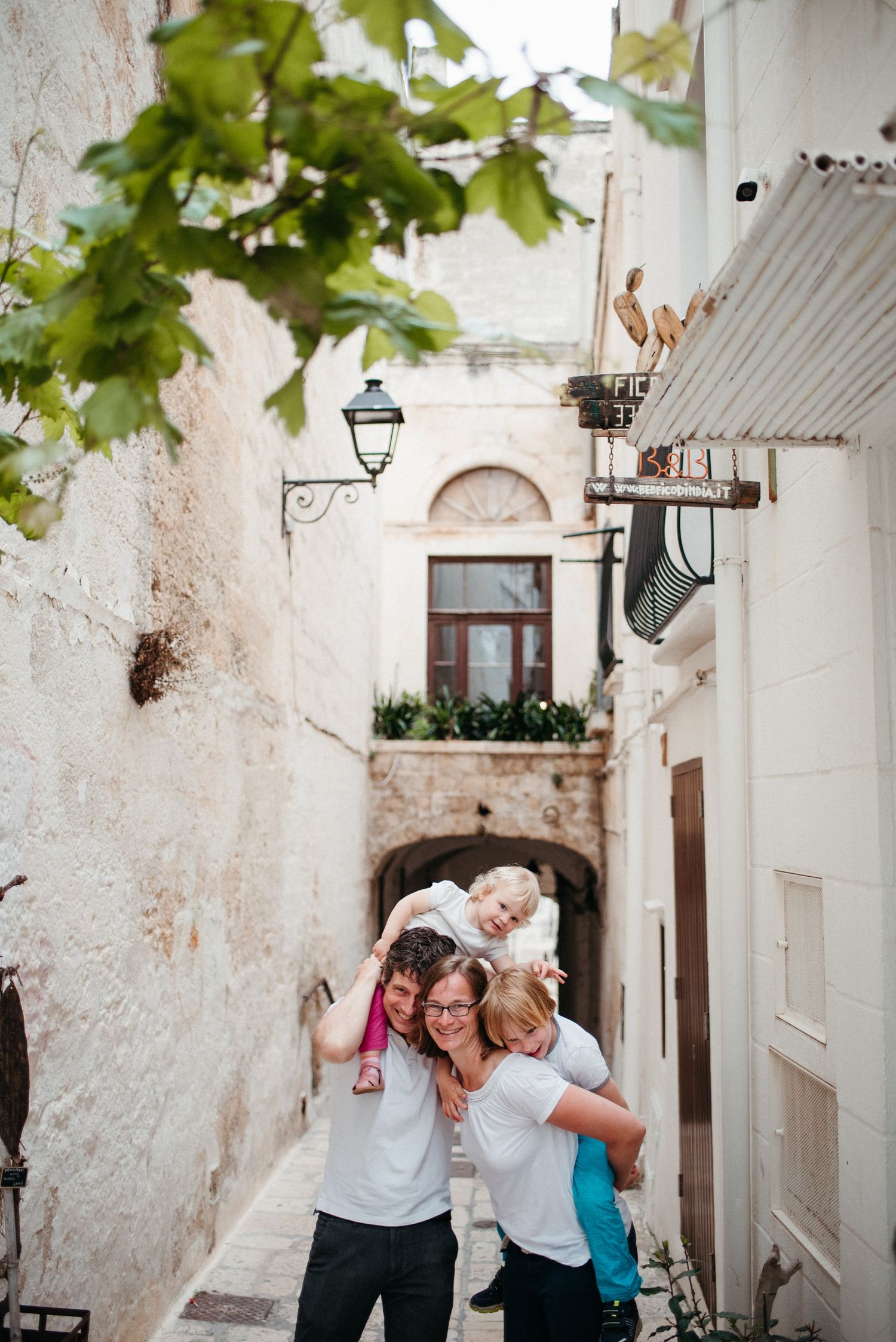 People celebrate and dance together in a charming white-walled Mediterranean street.