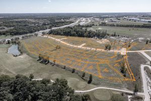 Aerial view of a large property layout with orange markings showing development or subdivision plans.