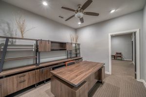 Modern storage room with wooden shelving units and a center island featuring clean lines and ambient lighting.