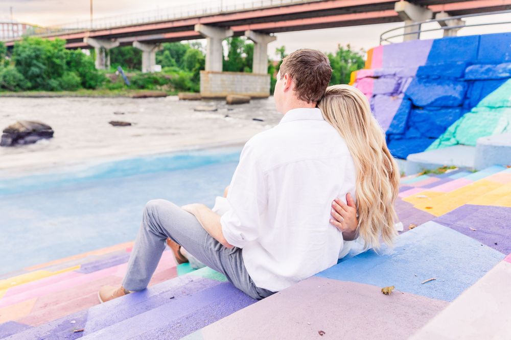 Couple sitting together on colorful painted steps enjoying peaceful moment.