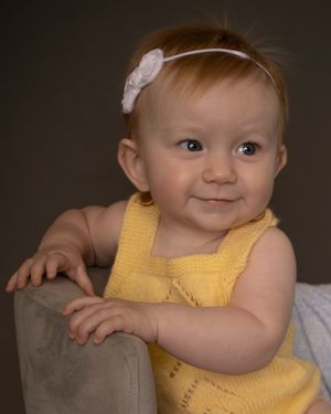 A baby girl twists to the side