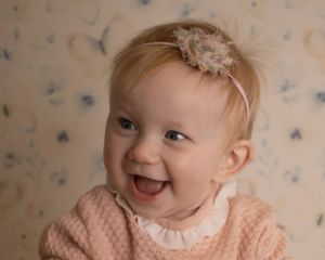 A baby girl gives a wide smile